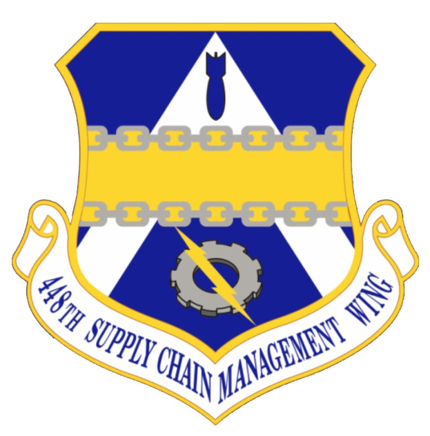 Logo des 48. Versorgungsgeschwader mit einem blauen Schild mit einem weißen Stern, einem weißen Banner mit blauer Schrift 'Versorgungsgeschwader' und schwarzer Schrift '48. Versorgungsgeschwader' in fetter Schrift.