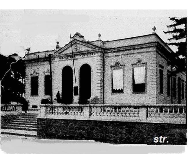 Schwarzes und weißes Foto eines Gebäudes mit der Beschriftung 'Präfektur-Municipal Office, San Francisco, California' mit Fenstern, Türen, Säulen, Treppen, Geländern, Pflanzen, Bäumen und Himmel im Hintergrund.